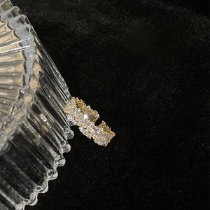 Detail of adjustable gold ring featuring sparkling cubic zirconia in micro-pave setting