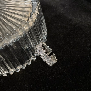 Macro view of adjustable open ring featuring sparkling baguette and round-cut cubic zirconia