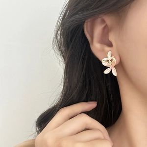 Elegant gold-plated pink and white floral earrings on model for a romantic chic look