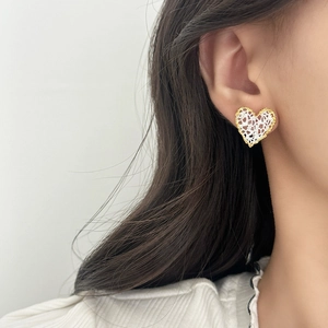 French style heart-shaped lace earrings in gold trim shown on model for daily wear