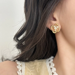 French vintage gold hollow flower earrings with cubic zirconia on a model