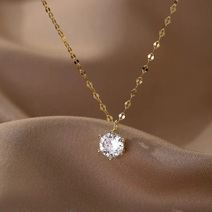 Close-up of gold chain necklace with round brilliant-cut cubic zirconia in six-prong setting