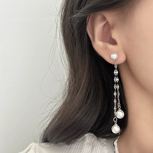 Elegant long pearl tassel earrings with silver chains on a female model for daily style