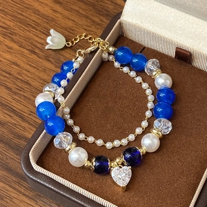 Double-layer beaded bracelet with blue crystals, pearls, and heart zircon charm