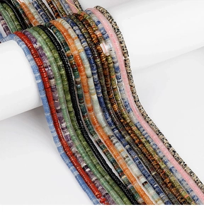Close-up of colorful natural stone heishi spacer beads on a display for DIY jewelry