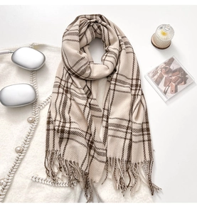 Detailed view of beige and brown checkered scarf with soft long fringe tassels