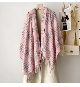 Detail of pink and grey checkered tassel shawl with soft texture on a beige coat