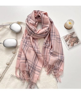 Detail of pink and gray checkered scarf with soft fringe tassels and cashmere texture
