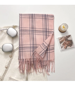 Close-up of pink checkered scarf with long tassels and soft cashmere texture
