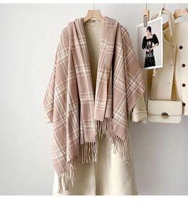 Close-up of pink and white checkered scarf with soft fringe details and thick texture