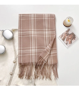 Detail of soft brown and beige plaid scarf texture with elegant hanging fringe