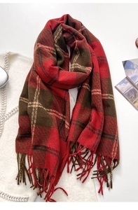 Detail of red-brown plaid scarf featuring handcrafted tassel fringe and thick texture