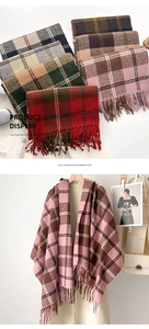 Detailed view of thick plaid scarves with soft fringes in classic tartan patterns