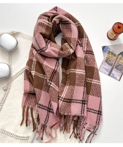 Detail shot of pink and brown plaid thick winter scarf with soft fringed edges