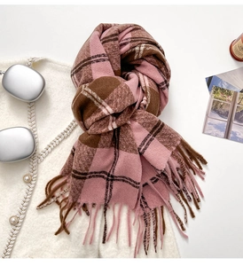 Detail of soft pink and brown plaid scarf with long fringes and thick winter texture