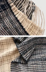 Primer plano de bufanda gruesa a cuadros con flecos en colores negro blanco y marrón suave