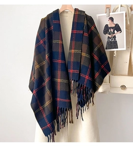 Detailed view of navy and brown plaid winter shawl with elegant tassel edges