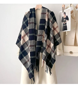Detail of plaid scarf with tassels on beige coat featuring navy and grey check pattern