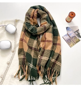 Classic checkered scarf in dark green and camel with elegant fringe tassels in a flat lay