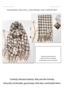 Close-up of thick beige and brown checkered scarf with fringe details and soft texture