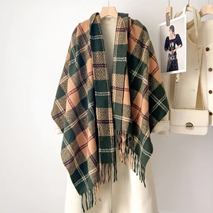 Thick plaid winter scarf with fringe tassels shown on a hanger with stylish accessories