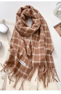 Close-up of brown and beige checkered cashmere scarf with fringe and woven label