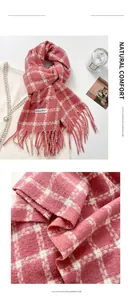 Detail of pink and white plaid imitation cashmere scarf with soft tassels and label