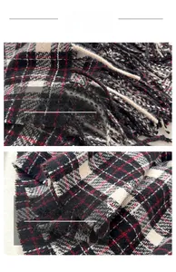 Close-up of red and black plaid scarf featuring soft fringe and detailed knit texture
