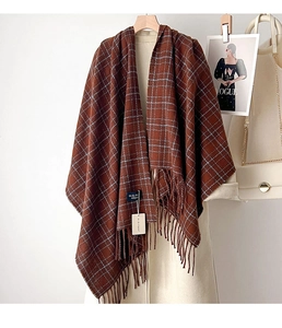 Close-up of deep brown plaid scarf with blue stripes and thick soft tassels details