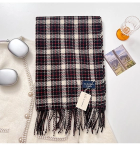 Detailed view of soft plaid cashmere scarf with fringes, labels and fashion accessories