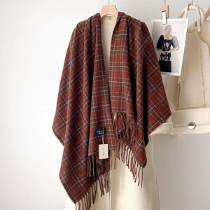 Brown and light blue plaid cashmere-like scarf with fringe on a wooden hanger