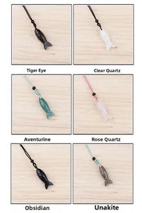 Variety of hand-carved natural gemstone fish pendants in tiger eye and rose quartz