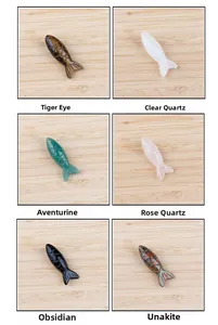 Macro detail of various natural gemstone fish pendants showing diverse crystal textures