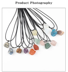 Macro shot of assorted irregular raw stone pendants on black cord necklaces