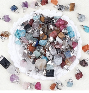 Close-up of mixed natural amethyst and quartz pendants with silver metal-edged borders