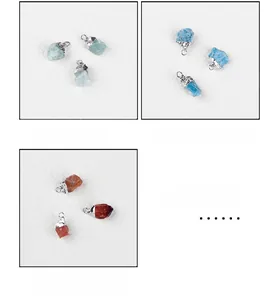 Detail view of fluorite, blue apatite, and red agate raw stone pendants with silver clasps
