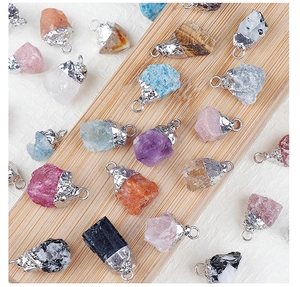 Macro shot of assorted raw crystal pendants with silver-plated irregular metal edges