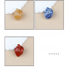 Detailed view of anatomical heart carvings in yellow stone, blue spot, and red jasper