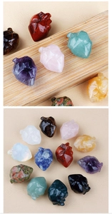 Detailed view of hand-carved natural gemstone anatomical hearts in various minerals