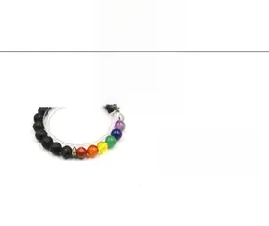 Macro detail of 8mm chakra beads bracelet with volcanic stones and colorful gems