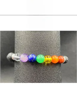 Detail of 7 chakra lava stone elastic bracelet with colorful beads and silver spacers