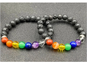 Close-up of dual lava stone chakra bracelets with colorful beads and silver spacers