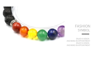 Detailed macro view of seven chakra beads and black lava stones with silver spacer bead