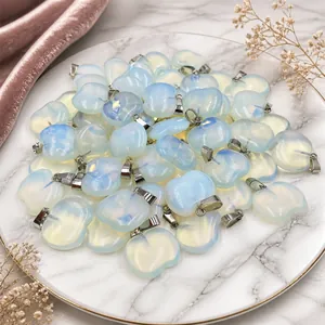 Bulk display of apple-shaped opalite pendants with vibrant blue and purple fire