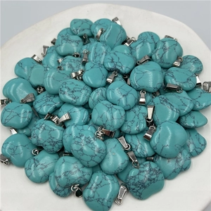 Detailed view of heart-shaped turquoise stone pendants with natural black vein textures