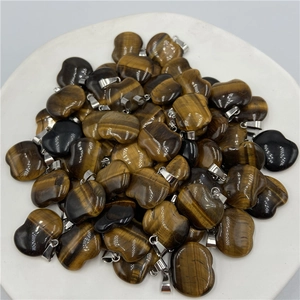 Macro detail of apple-shaped tiger eye stone pendants with polished silver clasps