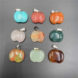Macro display of nine colorful apple-shaped gemstone pendants with silver metal clasps