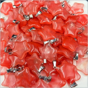 Bulk pile of translucent pink star-shaped stone pendants with silver metal clasps