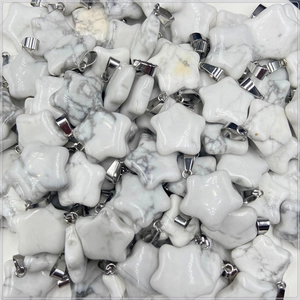Macro shot of bulk star-shaped howlite pendants with silver polished bails for jewelry
