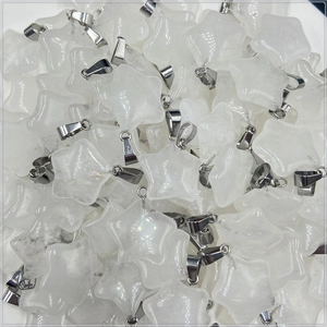Macro shot of bulk translucent white natural stone star pendants with silver bails
